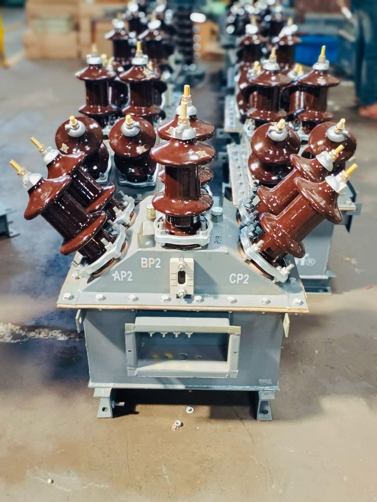 Combined CT-PT metering units with HV bushings, staged on the workshop floor